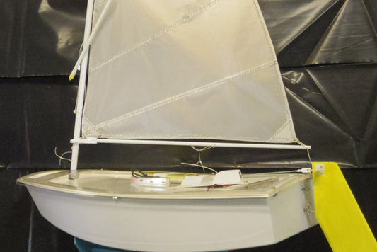 Mini Opti hull# 0150 White hull with Yellow Accents. Includes cradle, Radio Transmitter, and Servos. All setup and adjusted for easy sailing. Just find a pond, lake, or any place to set sail and enjoy.