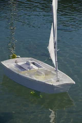 Mini Opti hull# 0150 White hull with Yellow Accents. Includes cradle, Radio Transmitter, and Servos. All setup and adjusted for easy sailing. Just find a pond, lake, or any place to set sail and enjoy.